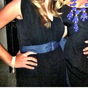 Black dress with blue tie accent.